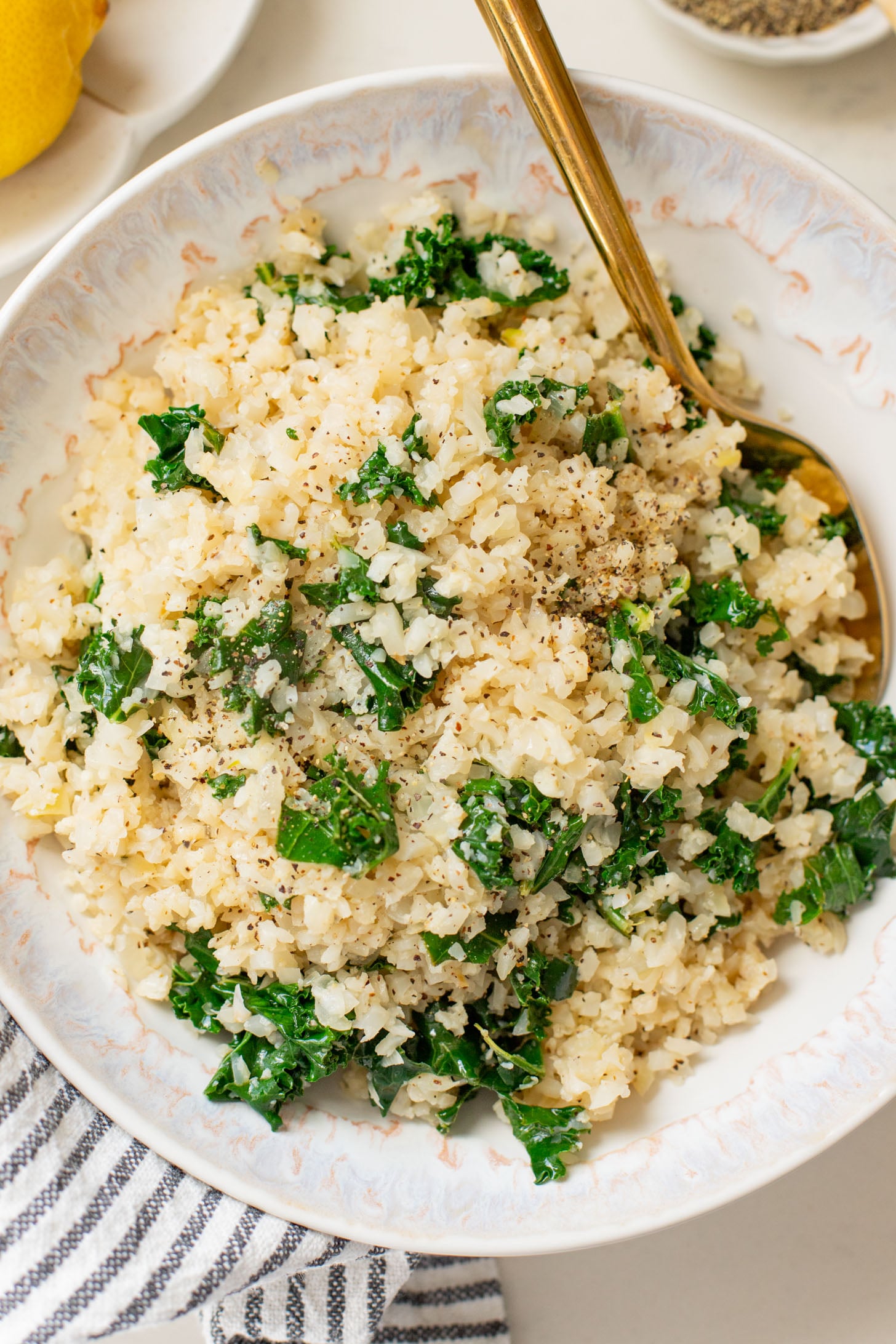 This Garlic Cauliflower Rice with Kale is a low carb rice alternative. The perfect veggie side dish that is packed with flavor | ThisSavoryVegan.com