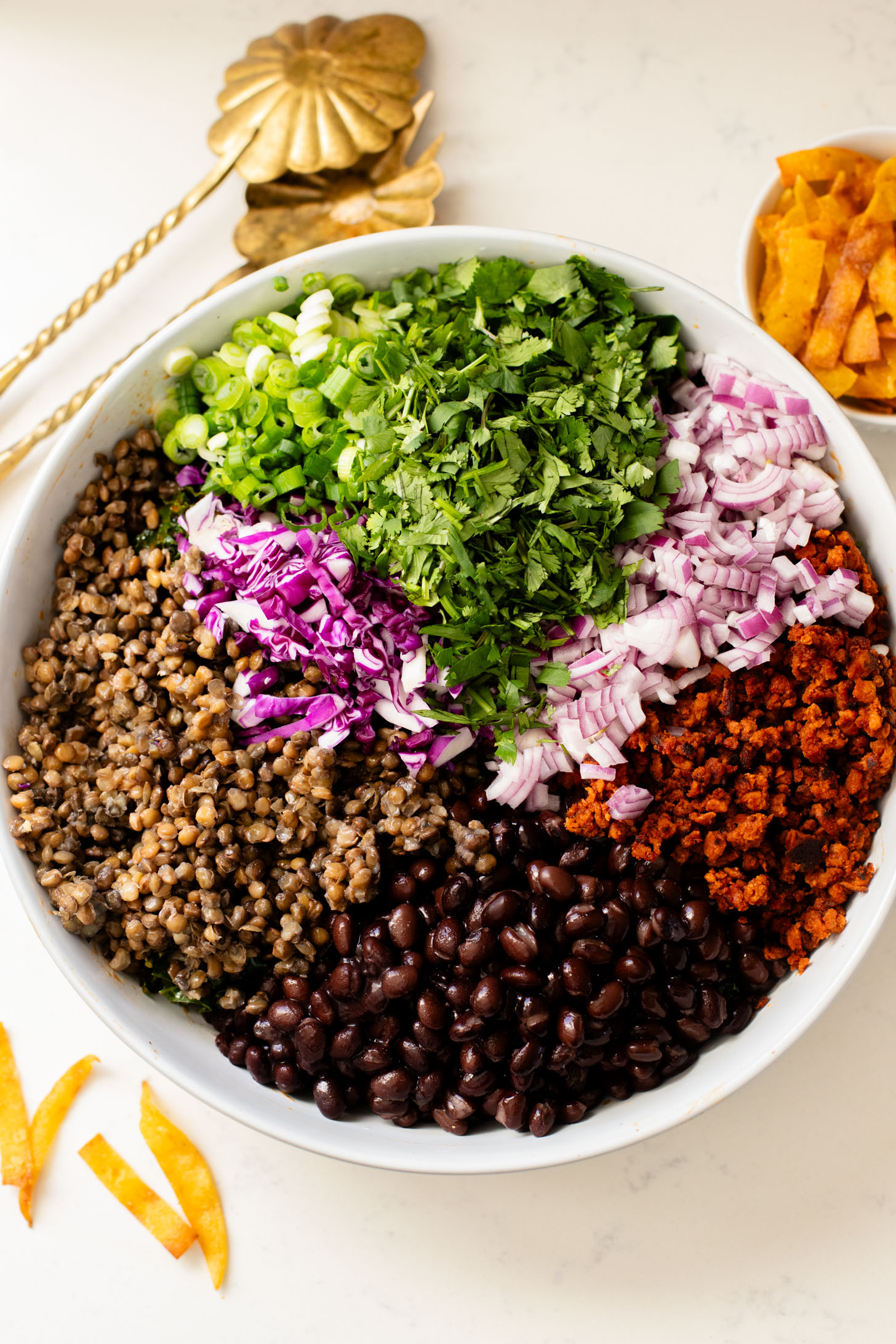 This Lentil & Bean Taco Salad is filled with kale, soy chorizo, greens, lentils & beans. All tossed in a zesty chipotle dressing | ThisSavoryVegan.com