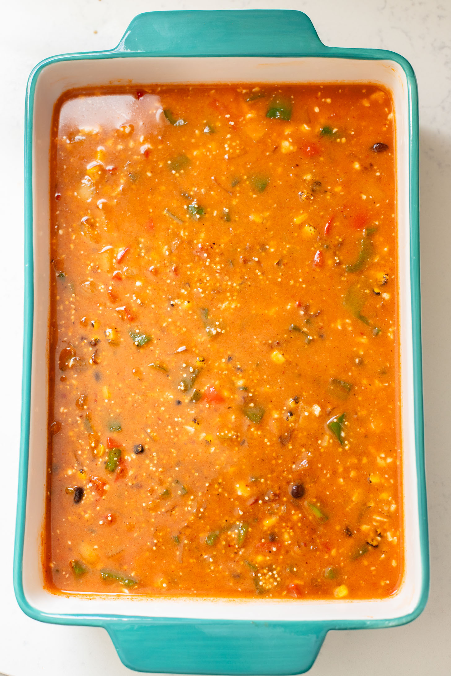 This Quinoa Enchilada Casserole is filled with plant-based protein & veggies. A super easy weeknight dinner that doesn't lack on flavor | ThisSavoryVegan.com