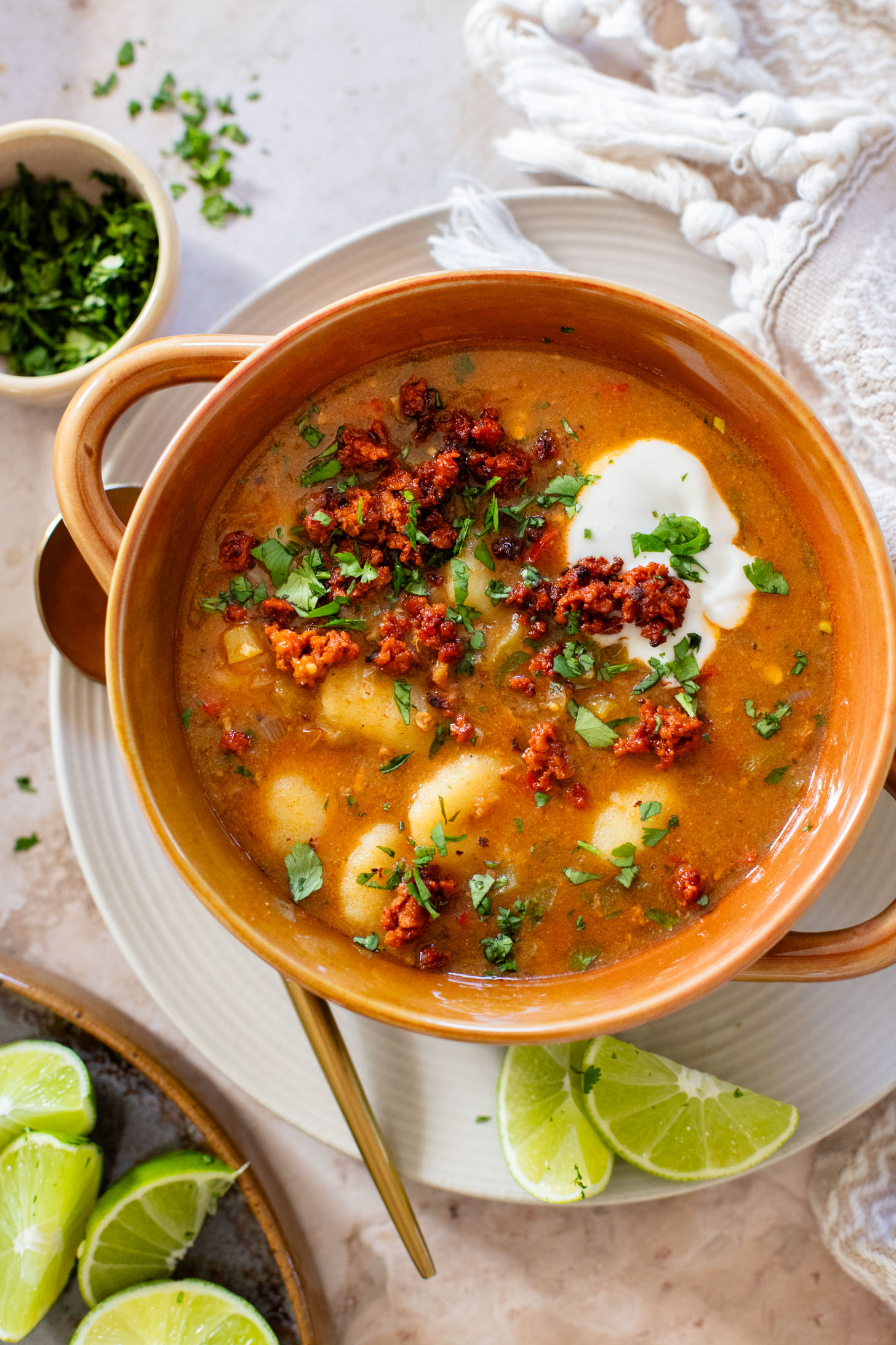 Comforting & cozy, this Salsa Verde Gnocchi Soup is packed with veggies, soy chorizo and tender gnocchi. Plant-based & delicious | ThisSavoryVegan.com