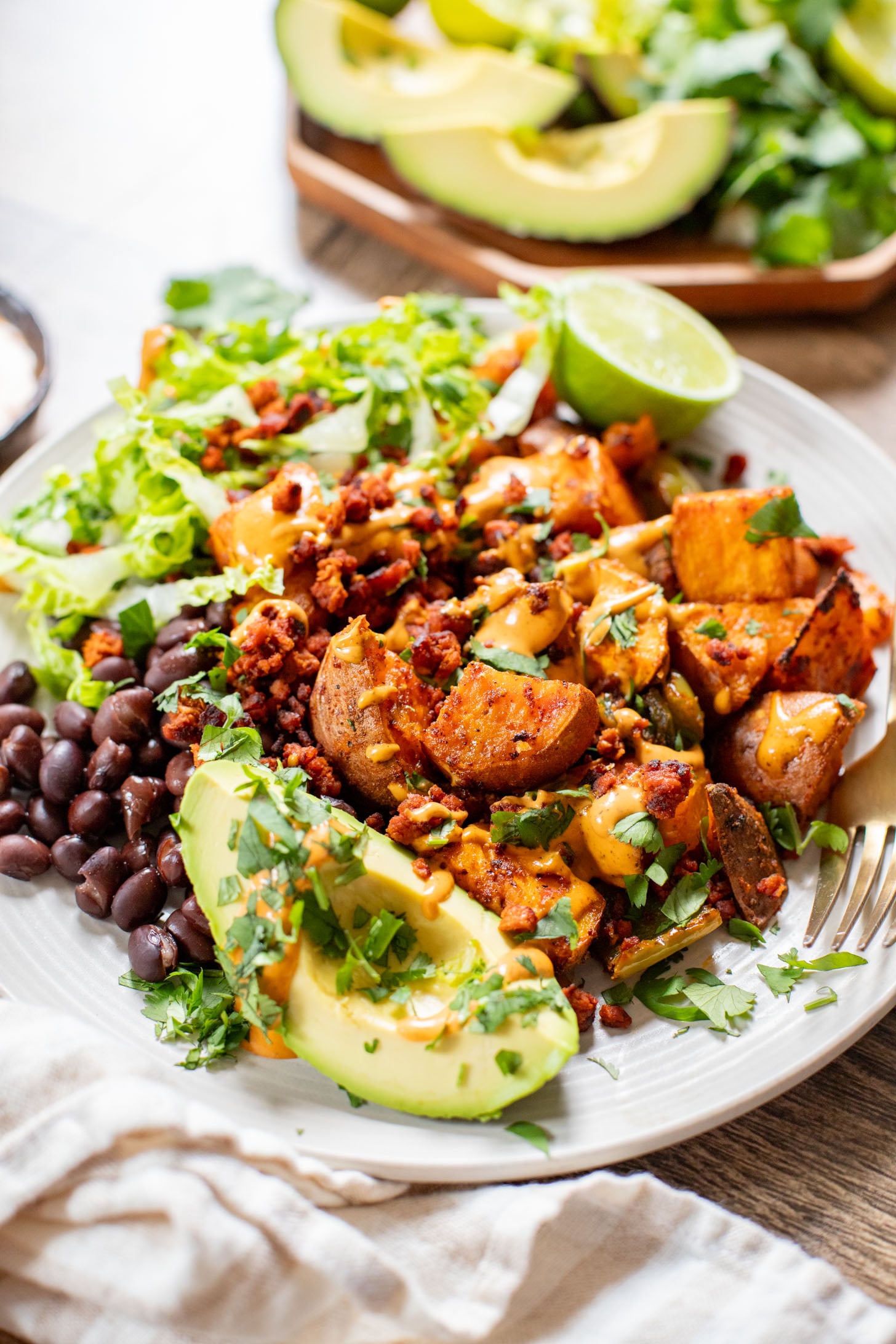 This Smoky Sweet Potatoes & Beans recipe is super versatile. Serve it as an easy sheet pan dinner or savory vegan brunch | ThisSavoryVegan.com