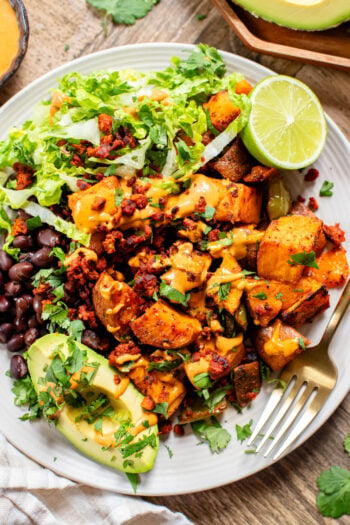This Smoky Sweet Potatoes & Beans recipe is super versatile. Serve it as an easy sheet pan dinner or savory vegan brunch | ThisSavoryVegan.com