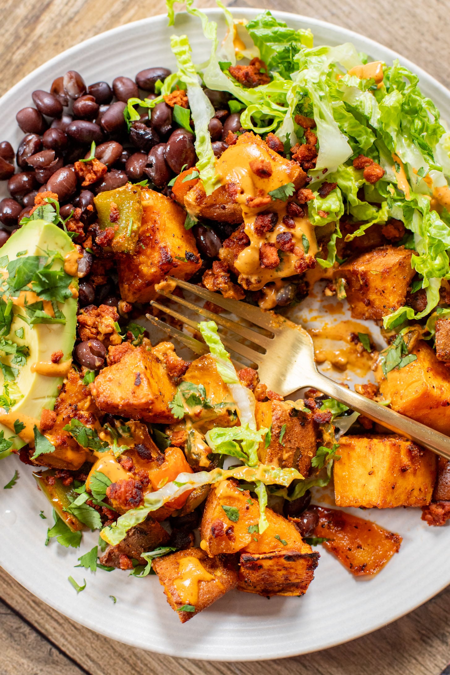 This Smoky Sweet Potatoes & Beans recipe is super versatile. Serve it as an easy sheet pan dinner or savory vegan brunch | ThisSavoryVegan.com