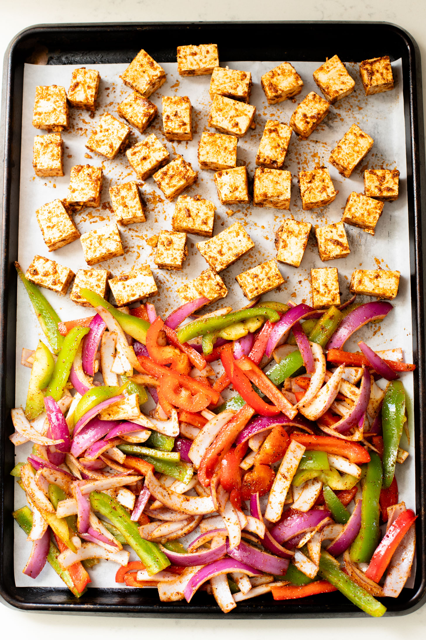 These Tofu Fajita Rice Bowls are a quick sheet pan dinner recipe! Packed with protein & veggies, and topped with avocado salsa | ThisSavoryVegan.com