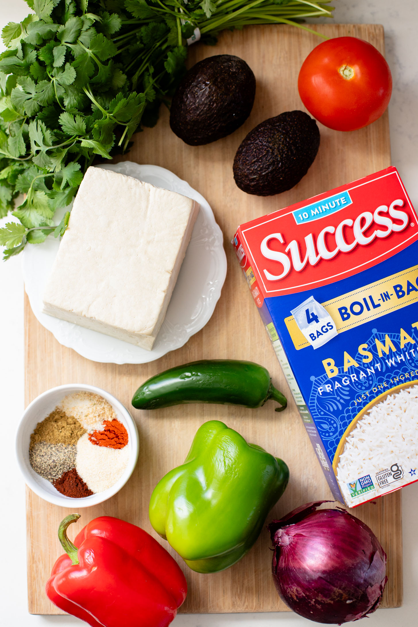 These Tofu Fajita Rice Bowls are a quick sheet pan dinner recipe! Packed with protein & veggies, and topped with avocado salsa | ThisSavoryVegan.com