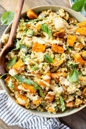 This Ginger & Herb Sweet Potato Quinoa Salad is a flavor bomb! Roasted sweet potatoes, tender quinoa, fresh herbs and the best ginger dressing | ThisSavoryVegan.com
