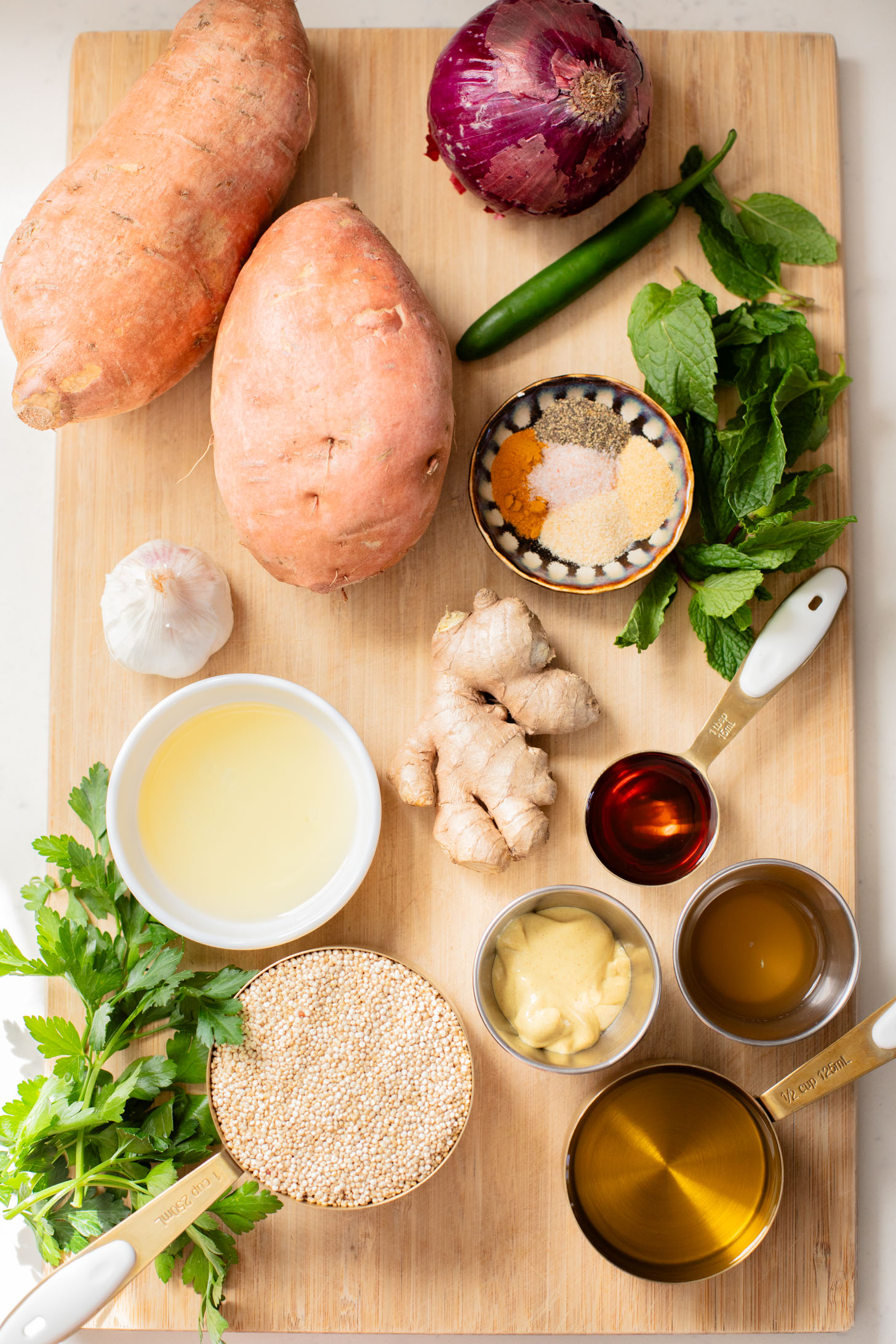 This Ginger & Herb Sweet Potato Quinoa Salad is a flavor bomb! Roasted sweet potatoes, tender quinoa, fresh herbs and the best ginger dressing | ThisSavoryVegan.com