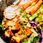 These Teriyaki Tofu Peanut Noodle Bowls are a mix between a salad and a bowl. Crispy tofu, lots of greens, rice noodles & peanut sauce | ThisSavoryVegan.com