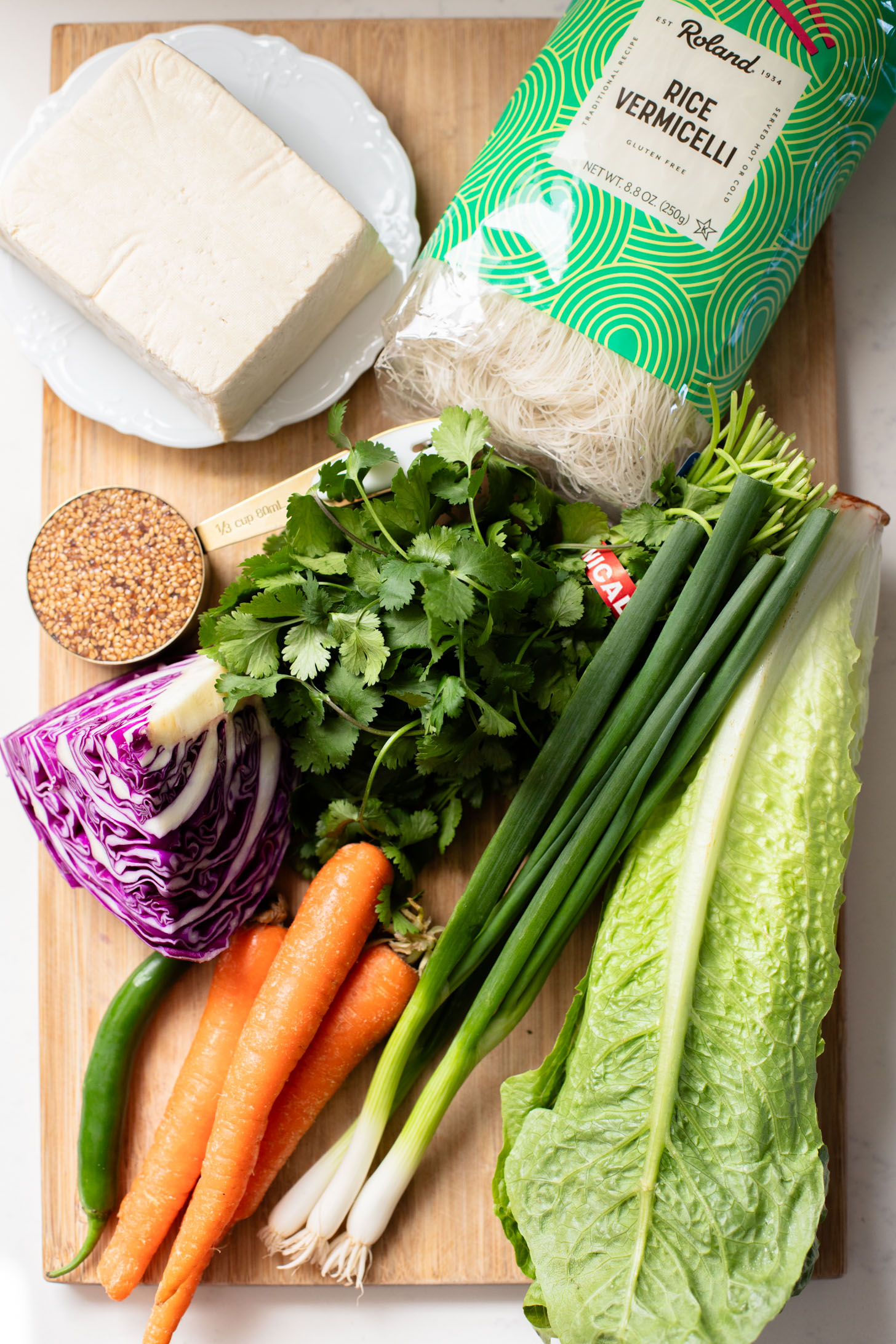 These Teriyaki Tofu Peanut Noodle Bowls are a mix between a salad and a bowl. Crispy tofu, lots of greens, rice noodles & peanut sauce | ThisSavoryVegan.com