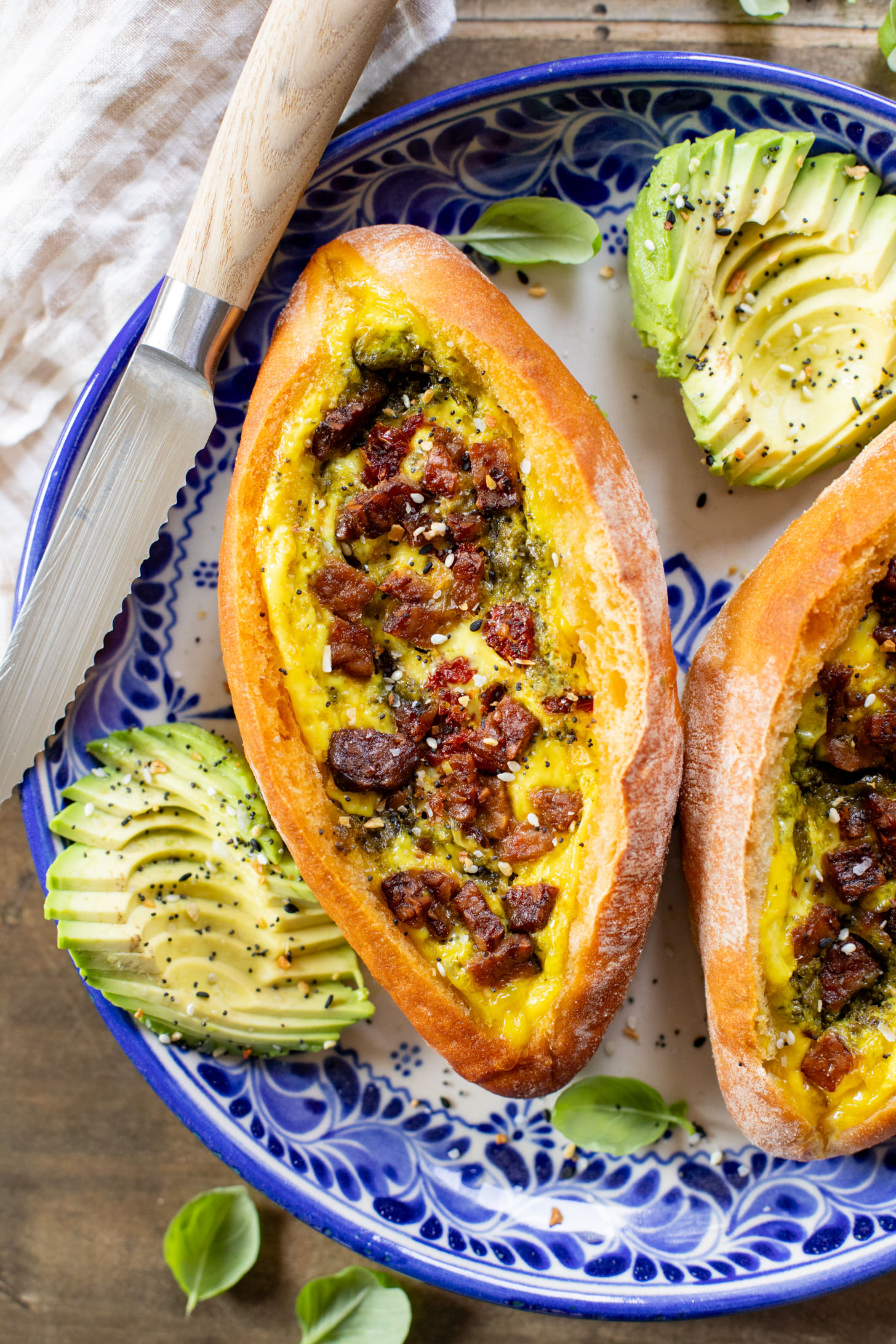These Baked Vegan Egg Boats are filled with Just egg, pesto, sun-dried tomatoes & tempeh bacon. Perfect for a vegan brunch | ThisSavoryVegan.com