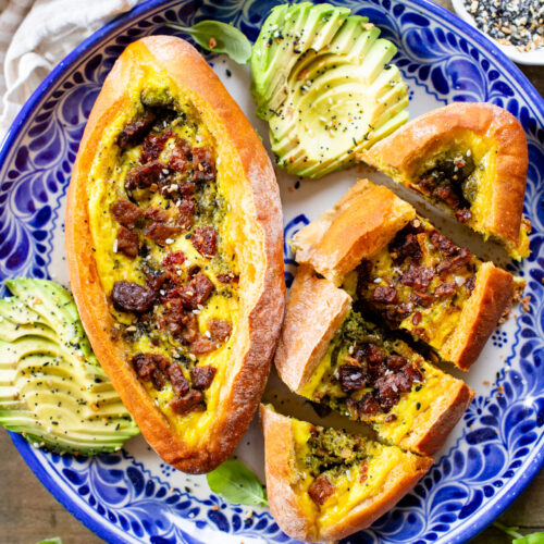 These Baked Vegan Egg Boats are filled with Just egg, pesto, sun-dried tomatoes & tempeh bacon. Perfect for a vegan brunch | ThisSavoryVegan.com