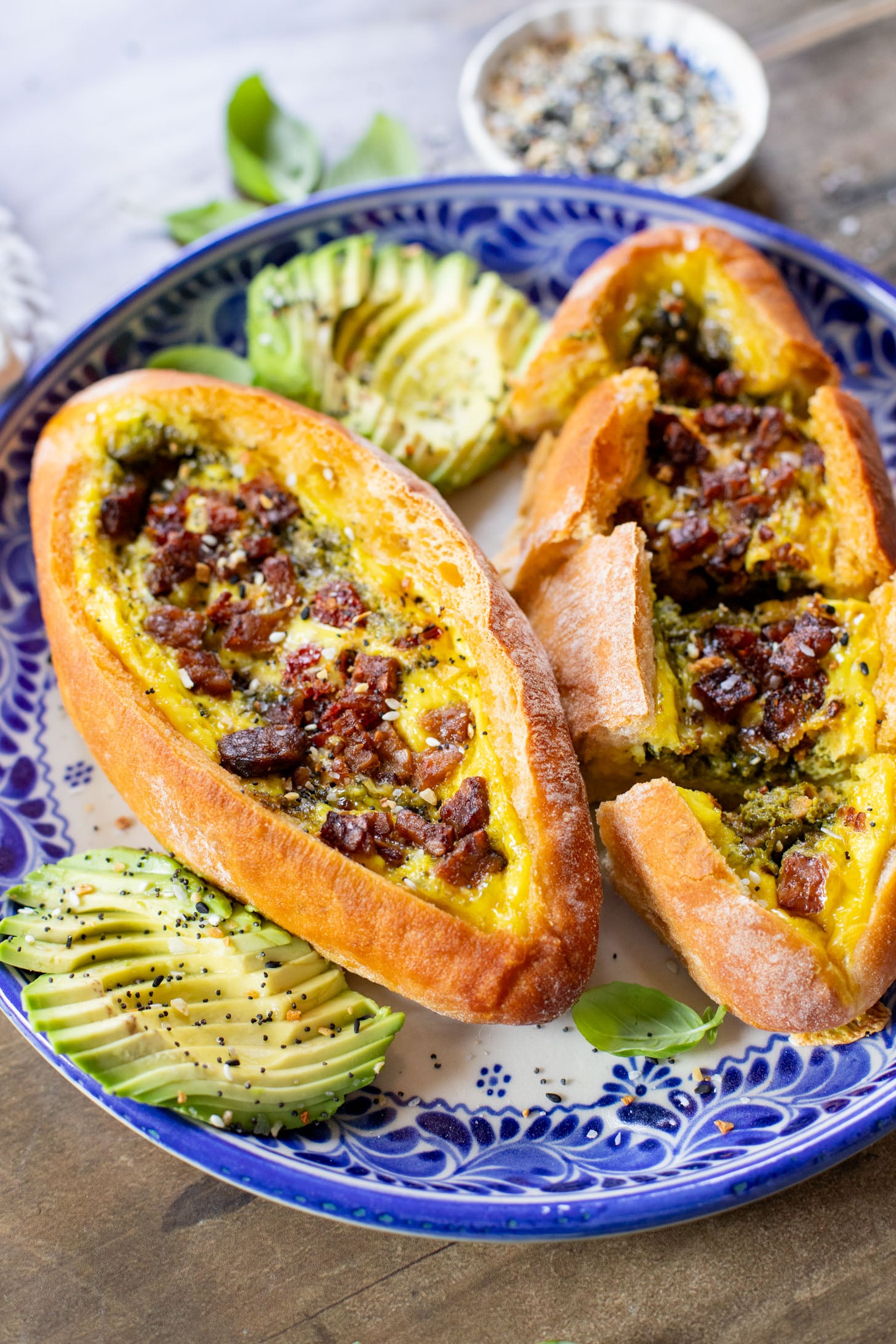 These Baked Vegan Egg Boats are filled with Just egg, pesto, sun-dried tomatoes & tempeh bacon. Perfect for a vegan brunch | ThisSavoryVegan.com