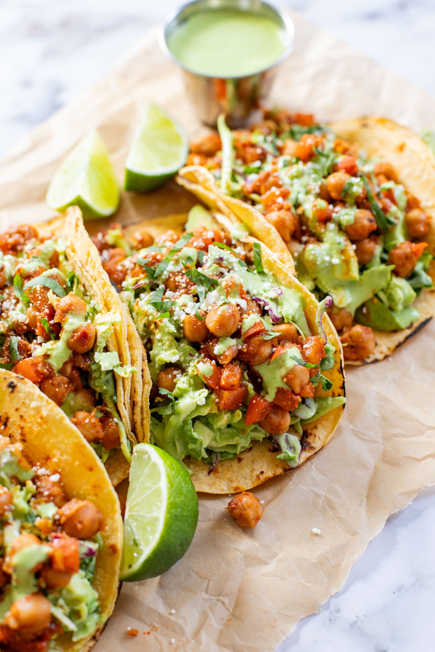 These Quick Chickpea Tacos are a weeknight staple! Made with a cilantro jalapeño slaw & super tasty chickpeas | ThisSavoryVegan.com