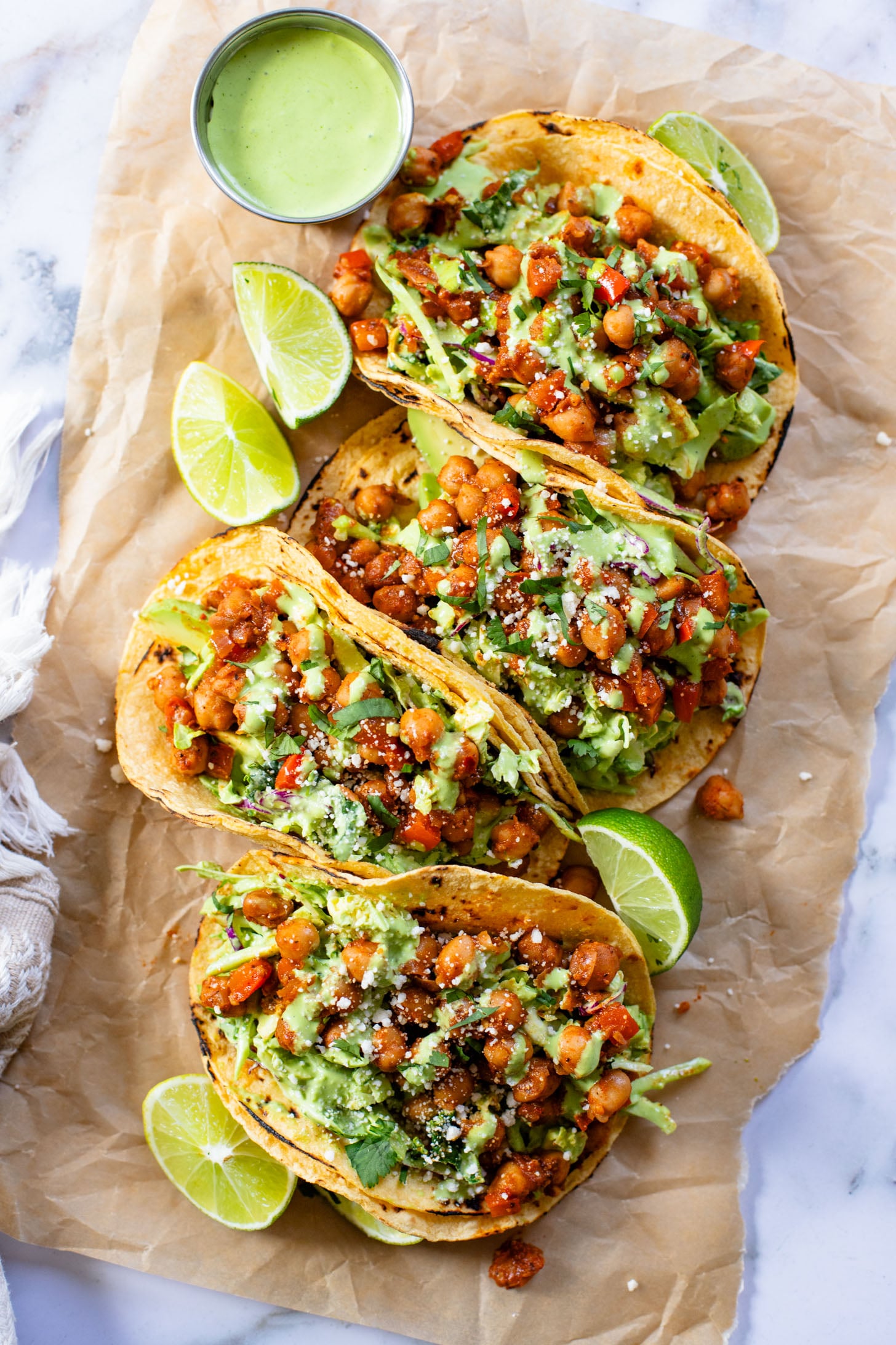 These Quick Chickpea Tacos are a weeknight staple! Made with a cilantro jalapeño slaw & super tasty chickpeas | ThisSavoryVegan.com
