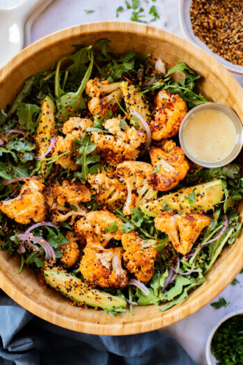 This Roasted Cauliflower Salad with Crispy Quinoa is super tasty & veggie-packed. Topped with the best vegan honey mustard dressing | ThisSavoryVegan.com