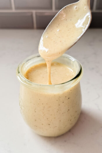 This Vegan Honey Mustard Dressing is the perfect simple & tangy dressing that can go with so many salads and wraps | ThisSavoryVegan.com