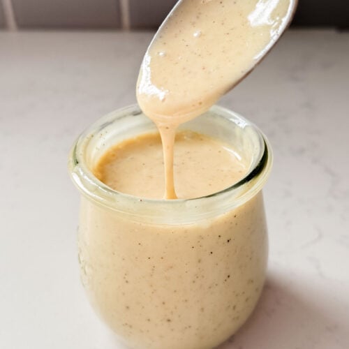 This Vegan Honey Mustard Dressing is the perfect simple & tangy dressing that can go with so many salads and wraps | ThisSavoryVegan.com
