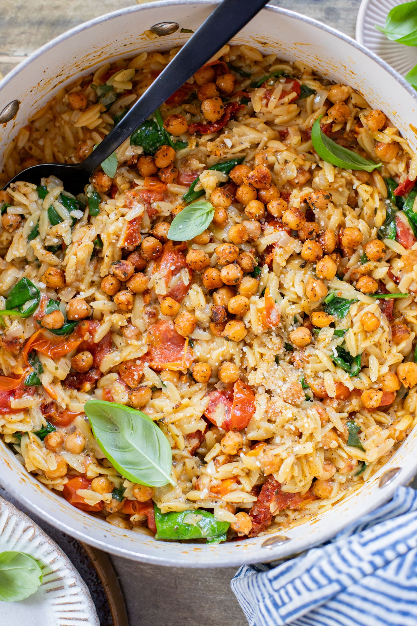 This Creamy Tuscan Chickpeas & Orzo recipe is a quick one-pot vegan dinner! Perfect meal when you want something comforting and easy | ThisSavoryVegan.com