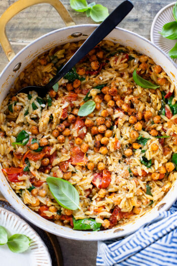 This Creamy Tuscan Chickpeas & Orzo recipe is a quick one-pot vegan dinner! Perfect meal when you want something comforting and easy | ThisSavoryVegan.com