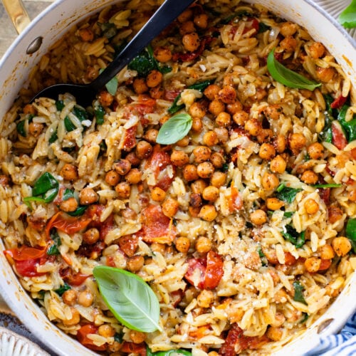 This Creamy Tuscan Chickpeas & Orzo recipe is a quick one-pot vegan dinner! Perfect meal when you want something comforting and easy | ThisSavoryVegan.com