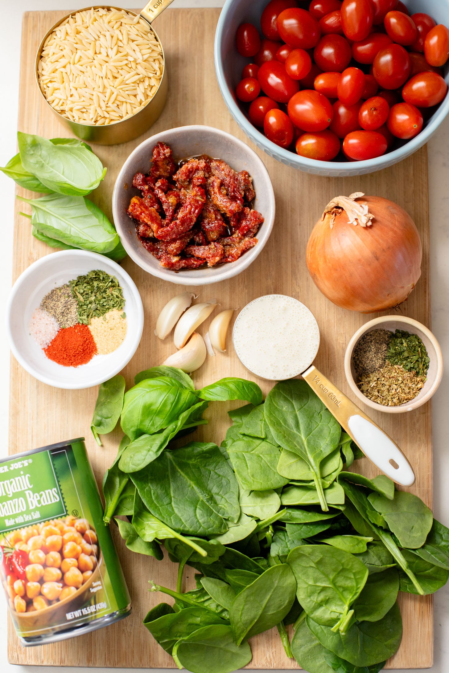 This Creamy Tuscan Chickpeas & Orzo recipe is a quick one-pot vegan dinner! Perfect meal when you want something comforting and easy | ThisSavoryVegan.com