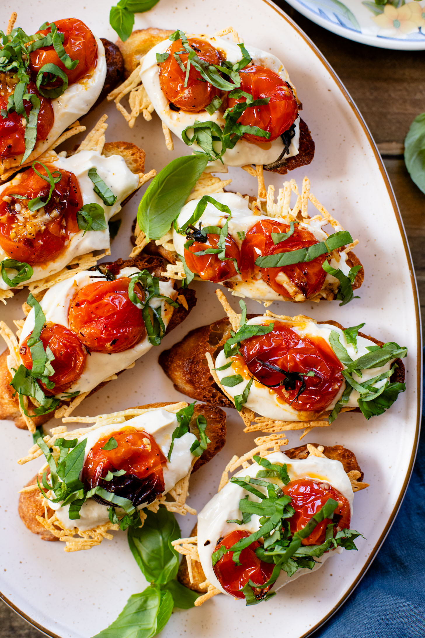 These Roasted Tomato & Ricotta Crostini are the best dairy-free appetizer! Bread slices are topped with vegan parm, tofu ricotta & burst tomatoes | ThisSavoryVegan.com