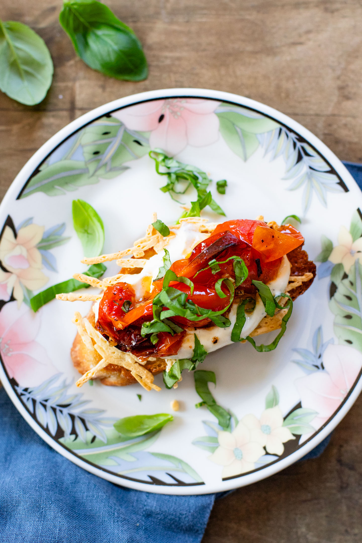 These Roasted Tomato & Ricotta Crostini are the best dairy-free appetizer! Bread slices are topped with vegan parm, tofu ricotta & burst tomatoes | ThisSavoryVegan.com