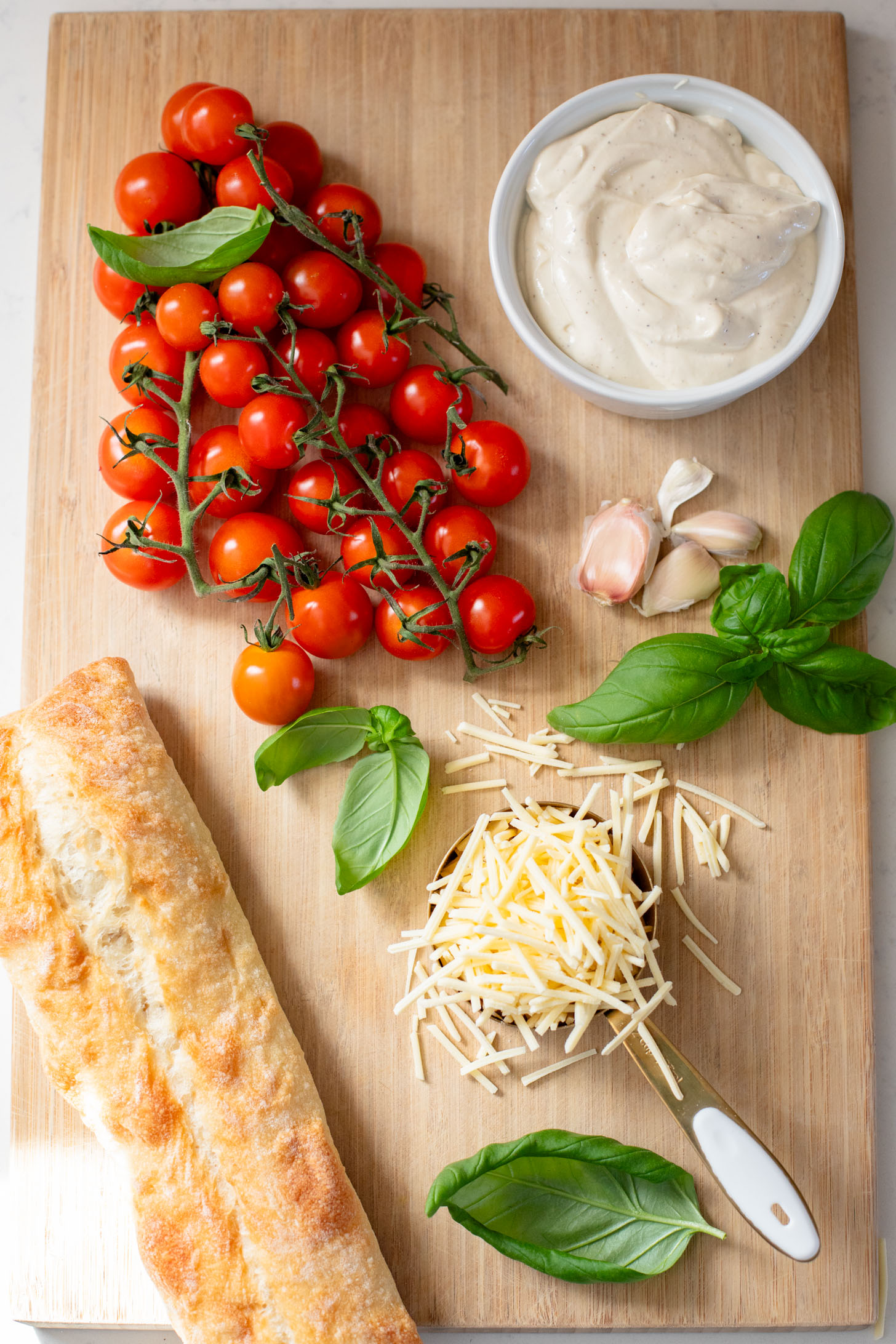 These Roasted Tomato & Ricotta Crostini are the best dairy-free appetizer! Bread slices are topped with vegan parm, tofu ricotta & burst tomatoes | ThisSavoryVegan.com