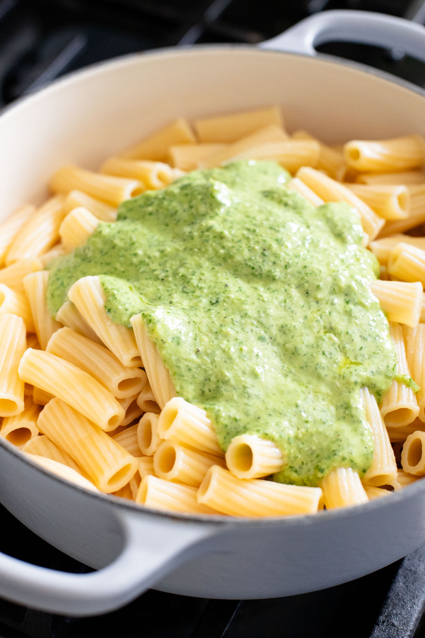 This Arugula Pesto Rigatoni is dairy-free and delicious. Arugula adds a peppery bite to the basil pesto. A quick & easy vegan dinner | ThisSavoryVegan.com