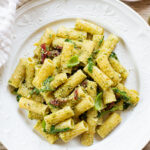 This Arugula Pesto Rigatoni is dairy-free and delicious. Arugula adds a peppery bite to the basil pesto. A quick & easy vegan dinner | ThisSavoryVegan.com