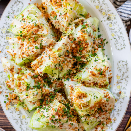This Spicy Caesar Wedge Salad is the BEST party salad. Made with vegan Caesar dressing and topped with garlic bread crumbs | ThisSavoryVegan.com