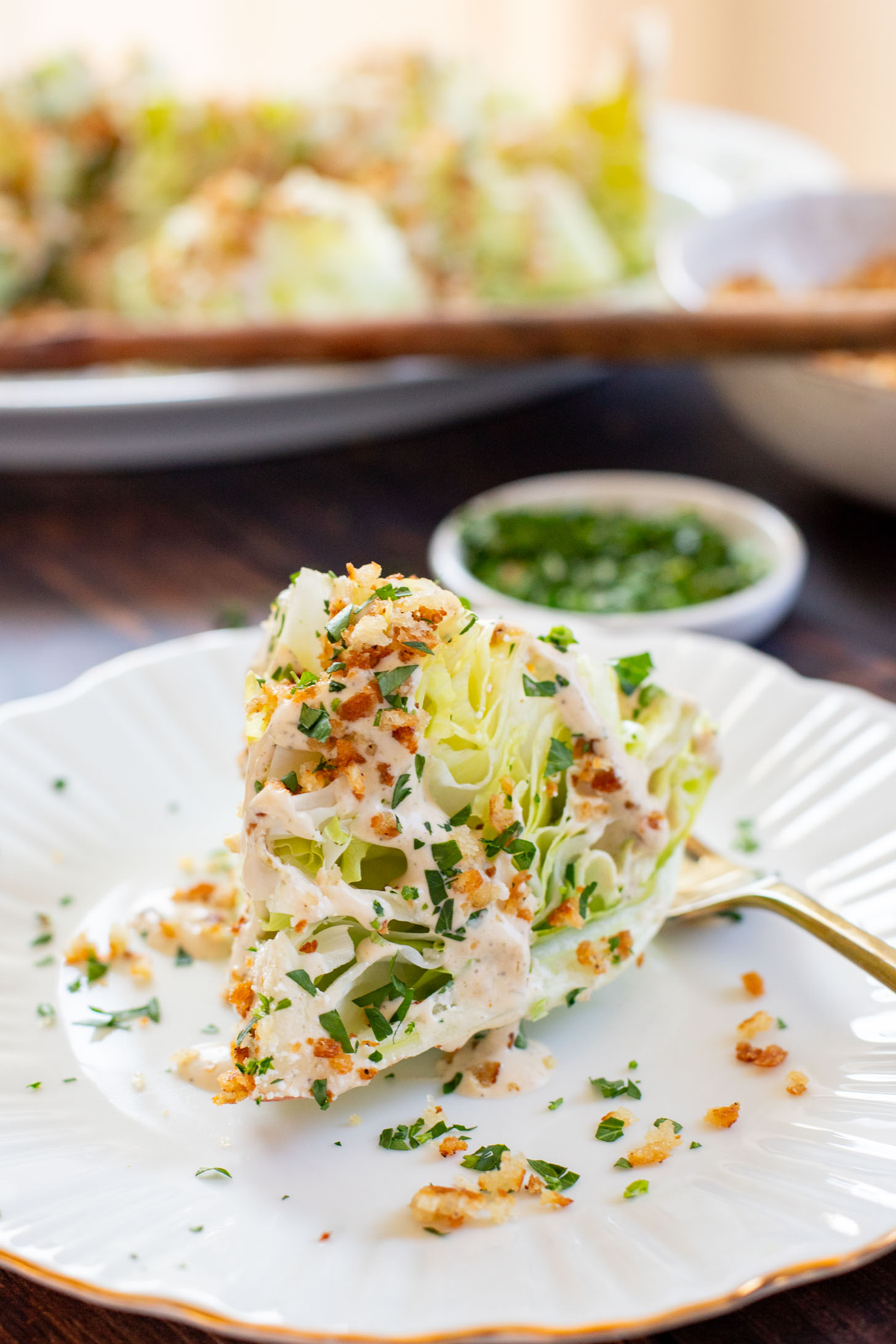 This Spicy Caesar Wedge Salad is the BEST party salad. Made with vegan Caesar dressing and topped with garlic bread crumbs | ThisSavoryVegan.com