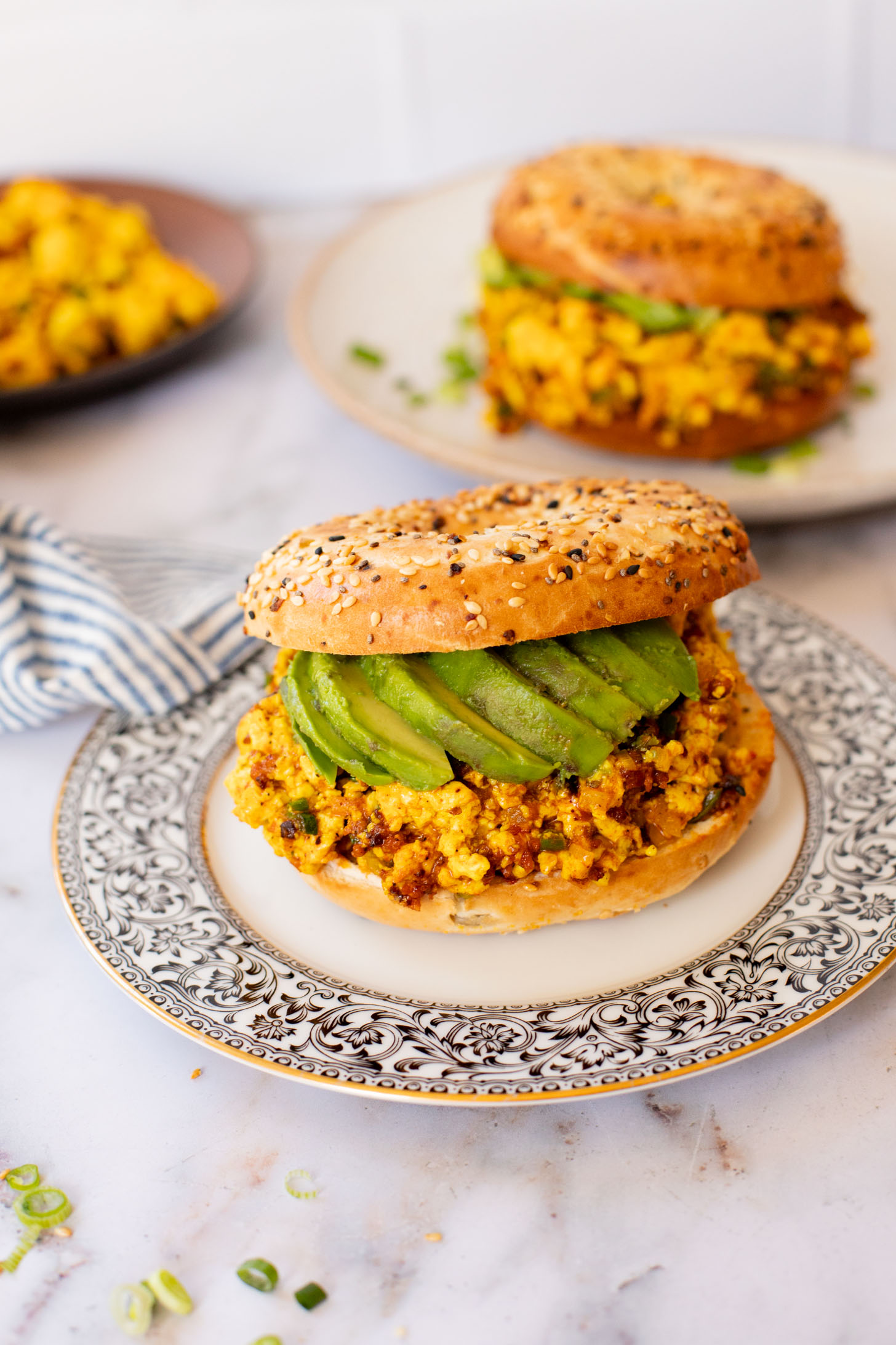 These Tofu Scramble Breakfast Sandwiches are perfect for a weekend brunch at home. This is the best vegan breakfast bagel | ThisSavoryVegan.com