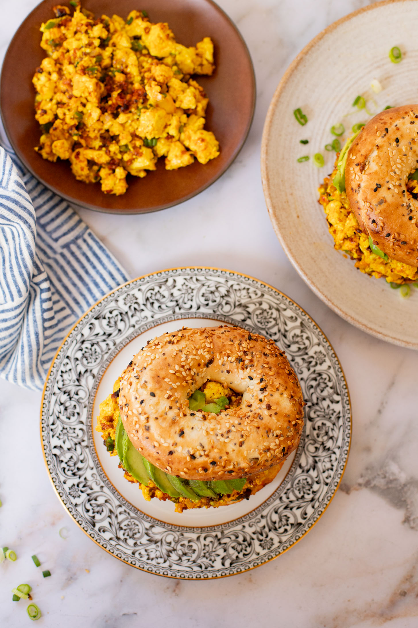 These Tofu Scramble Breakfast Sandwiches are perfect for a weekend brunch at home. This is the best vegan breakfast bagel | ThisSavoryVegan.com