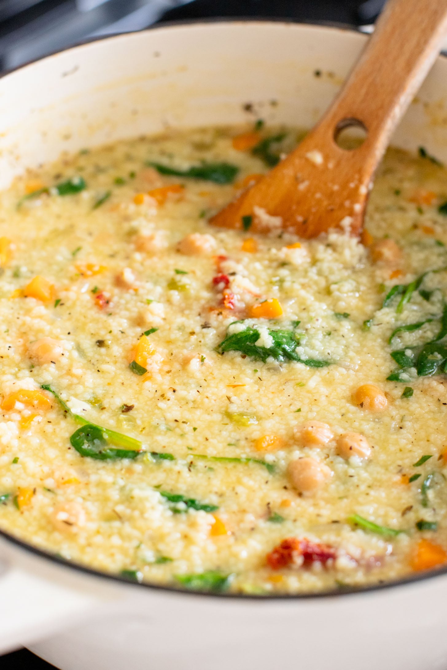 This Creamy Lemon Couscous Soup is bright and fresh. Made with a delicious broth, veggies, chickpeas, couscous and plenty of lemon juice | ThisSavoryVegan.com