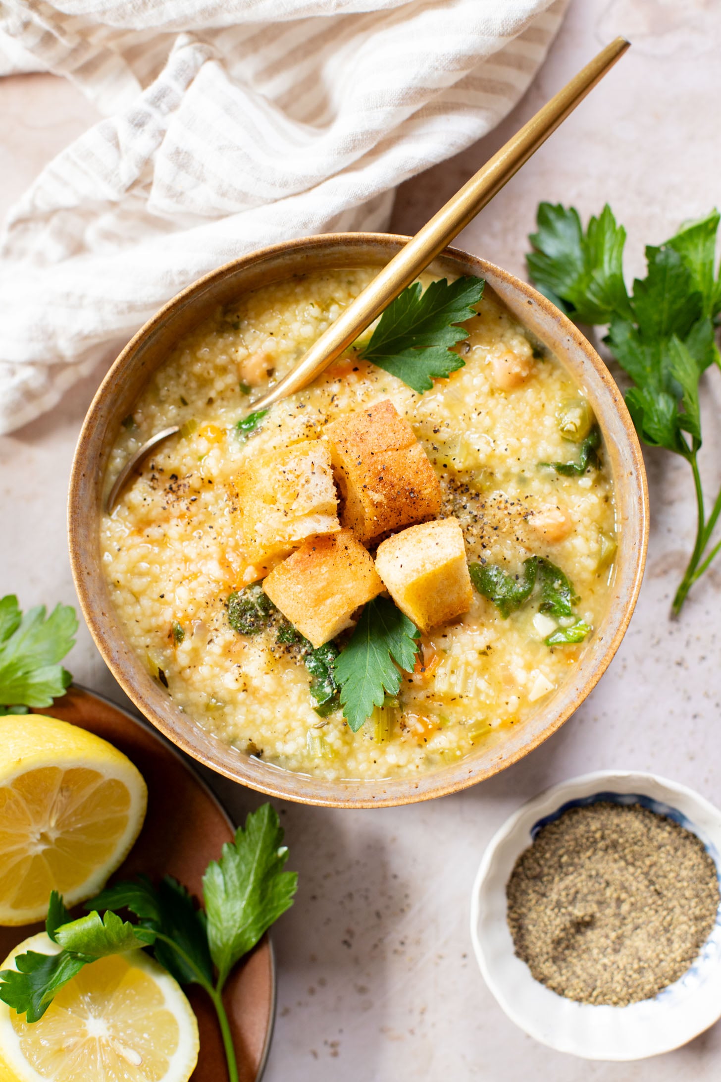 This Creamy Lemon Couscous Soup is bright and fresh. Made with a delicious broth, veggies, chickpeas, couscous and plenty of lemon juice | ThisSavoryVegan.com