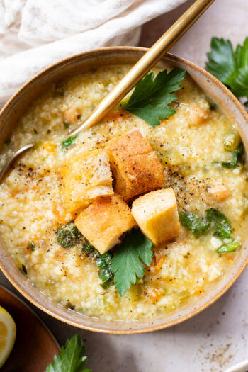 This Creamy Lemon Couscous Soup is bright and fresh. Made with a delicious broth, veggies, chickpeas, couscous and plenty of lemon juice | ThisSavoryVegan.com