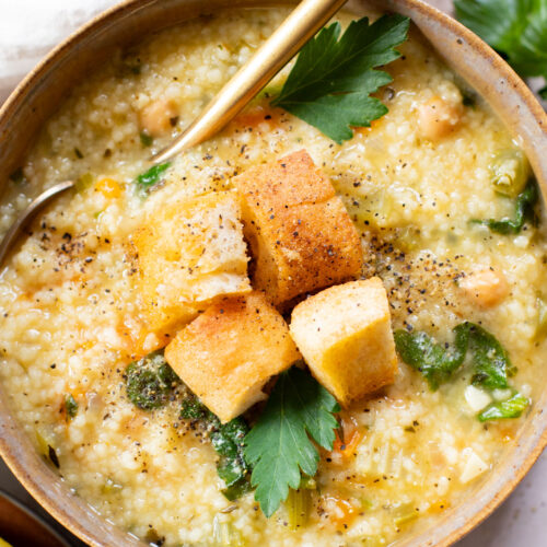 This Creamy Lemon Couscous Soup is bright and fresh. Made with a delicious broth, veggies, chickpeas, couscous and plenty of lemon juice | ThisSavoryVegan.com
