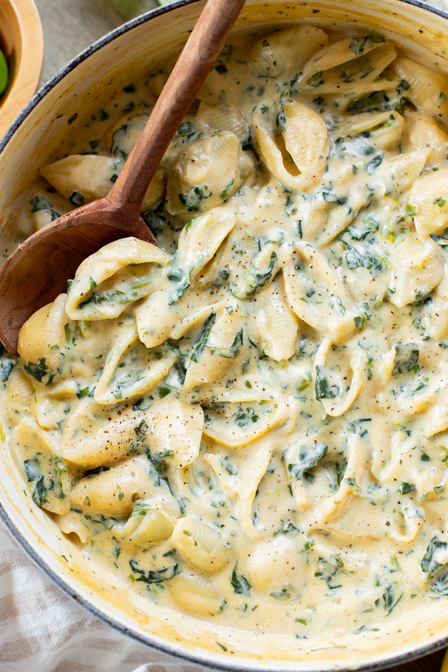 This Creamy Spinach Tofu Shells recipe is a comforting vegan pasta that sneaks in protein & veggies. Made in one pot for easy clean up | ThisSavoryVegan.com