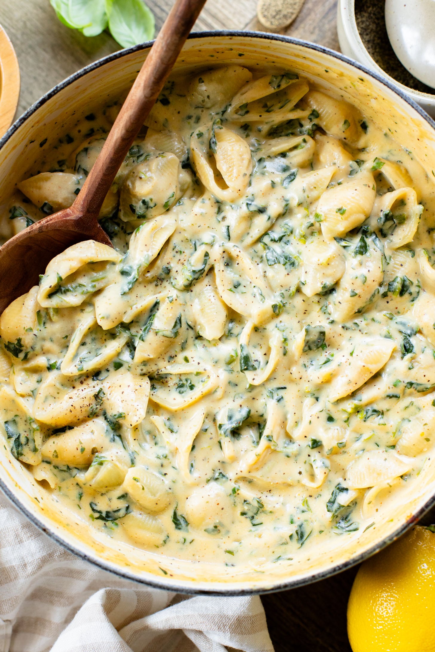 This Creamy Spinach Tofu Shells recipe is a comforting vegan pasta that sneaks in protein & veggies. Made in one pot for easy clean up | ThisSavoryVegan.com