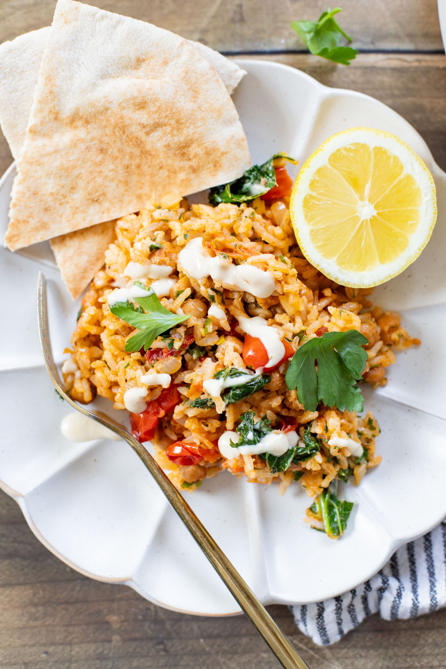This Mediterranean Chickpea & Rice Skillet is a quick & delicious vegan dinner. Crispy chickpeas, veggies, rice & a lemony hummus sauce | ThisSavoryVegan.com