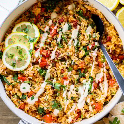 This Mediterranean Chickpea & Rice Skillet is a quick & delicious vegan dinner. Crispy chickpeas, veggies, rice & a lemony hummus sauce | ThisSavoryVegan.com