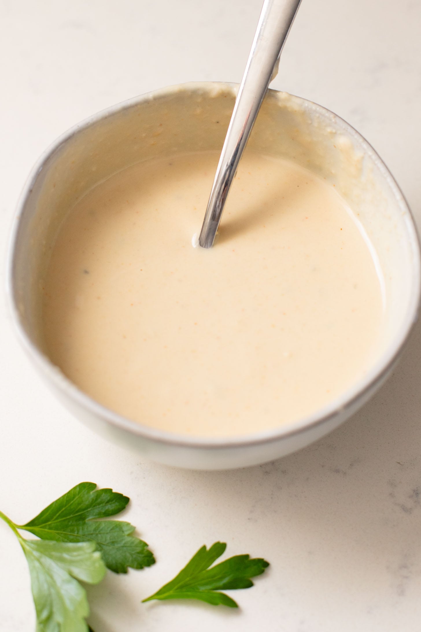 This Mediterranean Chickpea & Rice Skillet is a quick & delicious vegan dinner. Crispy chickpeas, veggies, rice & a lemony hummus sauce | ThisSavoryVegan.com