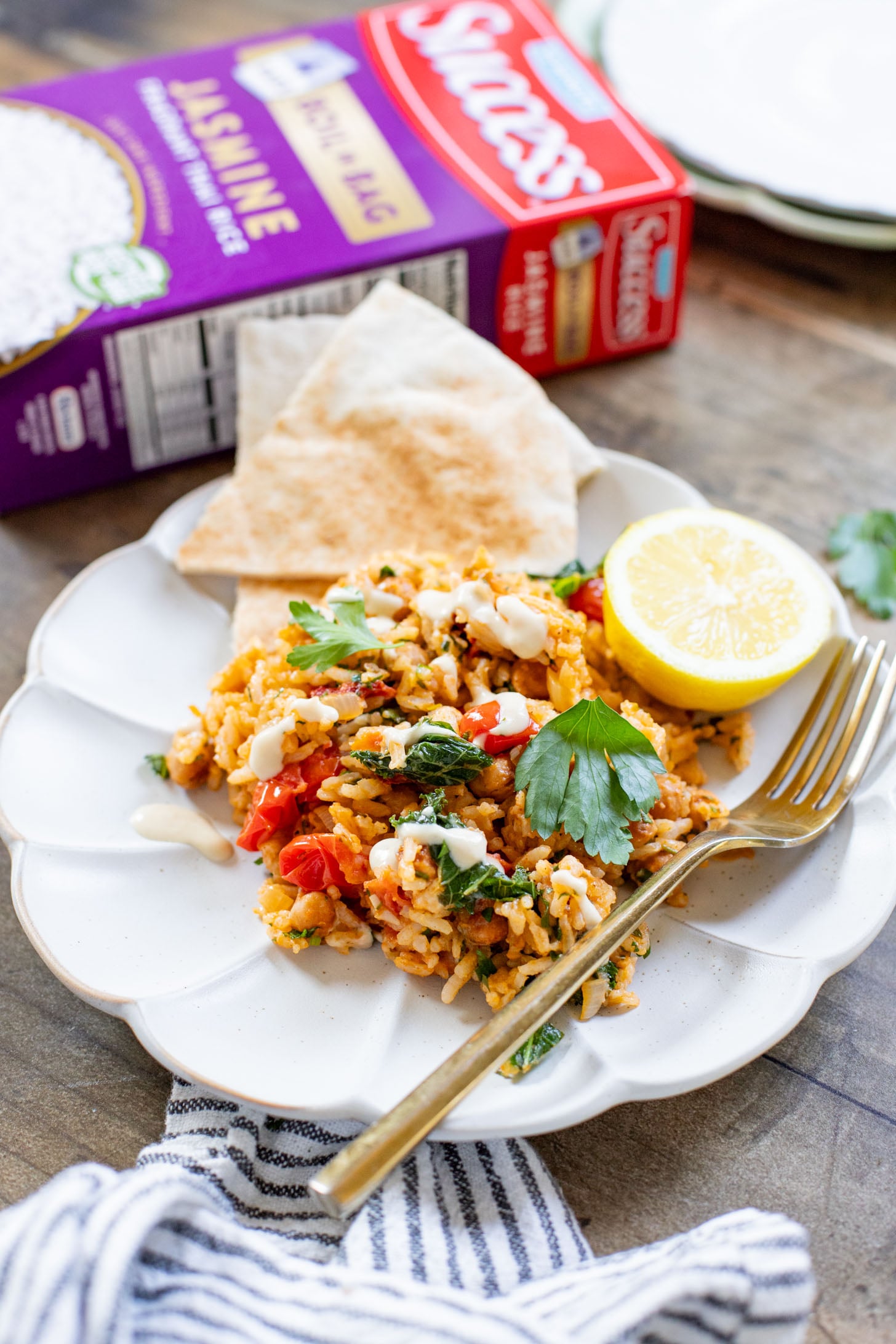 This Mediterranean Chickpea & Rice Skillet is a quick & delicious vegan dinner. Crispy chickpeas, veggies, rice & a lemony hummus sauce | ThisSavoryVegan.com