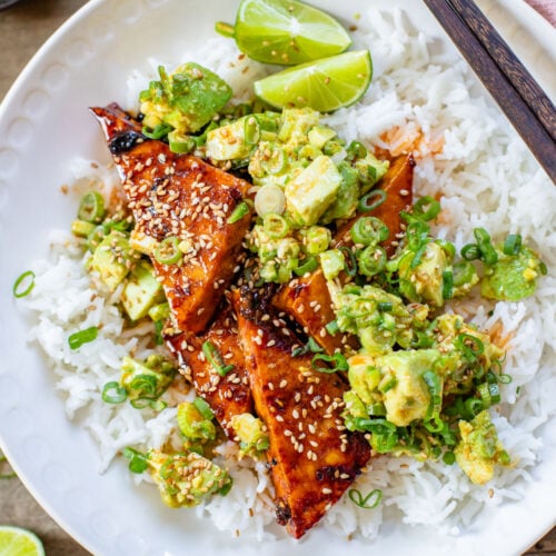 These Teriyaki Tofu Rice Bowls are a quick weeknight dinner. The tofu is sticky & crispy and is topped off with a ginger avocado salsa | ThisSavoryVegan.com