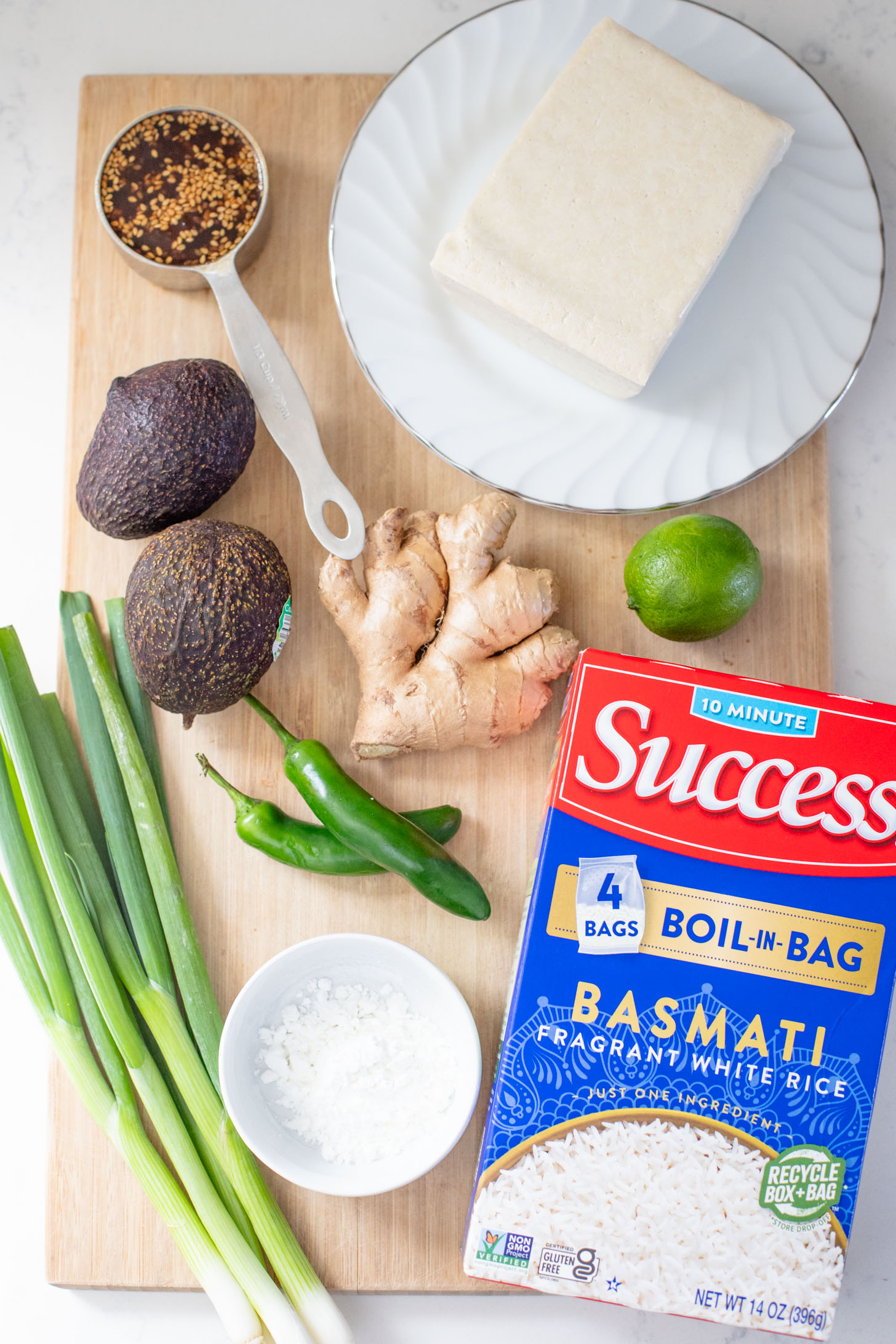 These Teriyaki Tofu Rice Bowls are a quick weeknight dinner. The tofu is sticky & crispy and is topped off with a ginger avocado salsa | ThisSavoryVegan.com