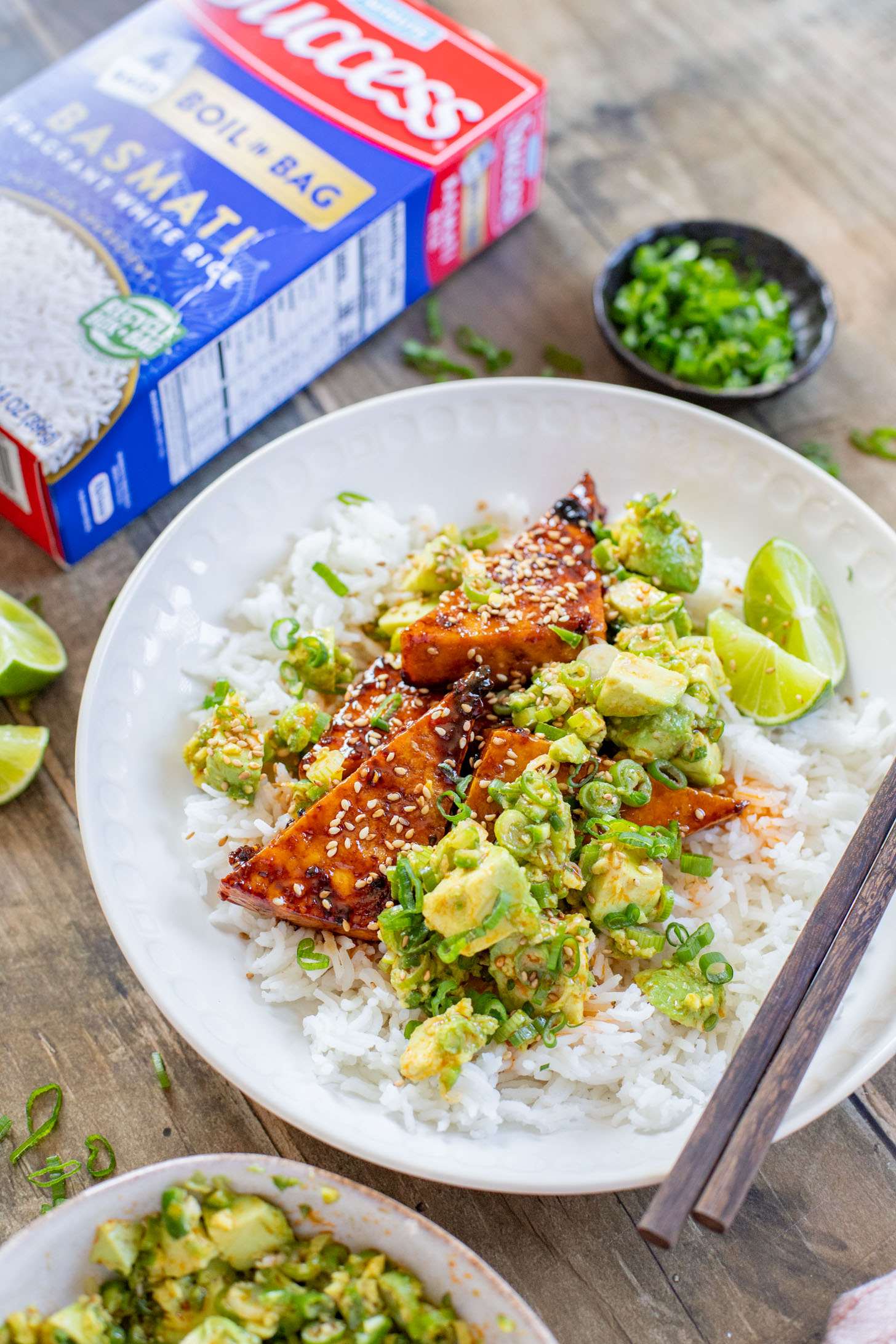 These Teriyaki Tofu Rice Bowls are a quick weeknight dinner. The tofu is sticky & crispy and is topped off with a ginger avocado salsa | ThisSavoryVegan.com