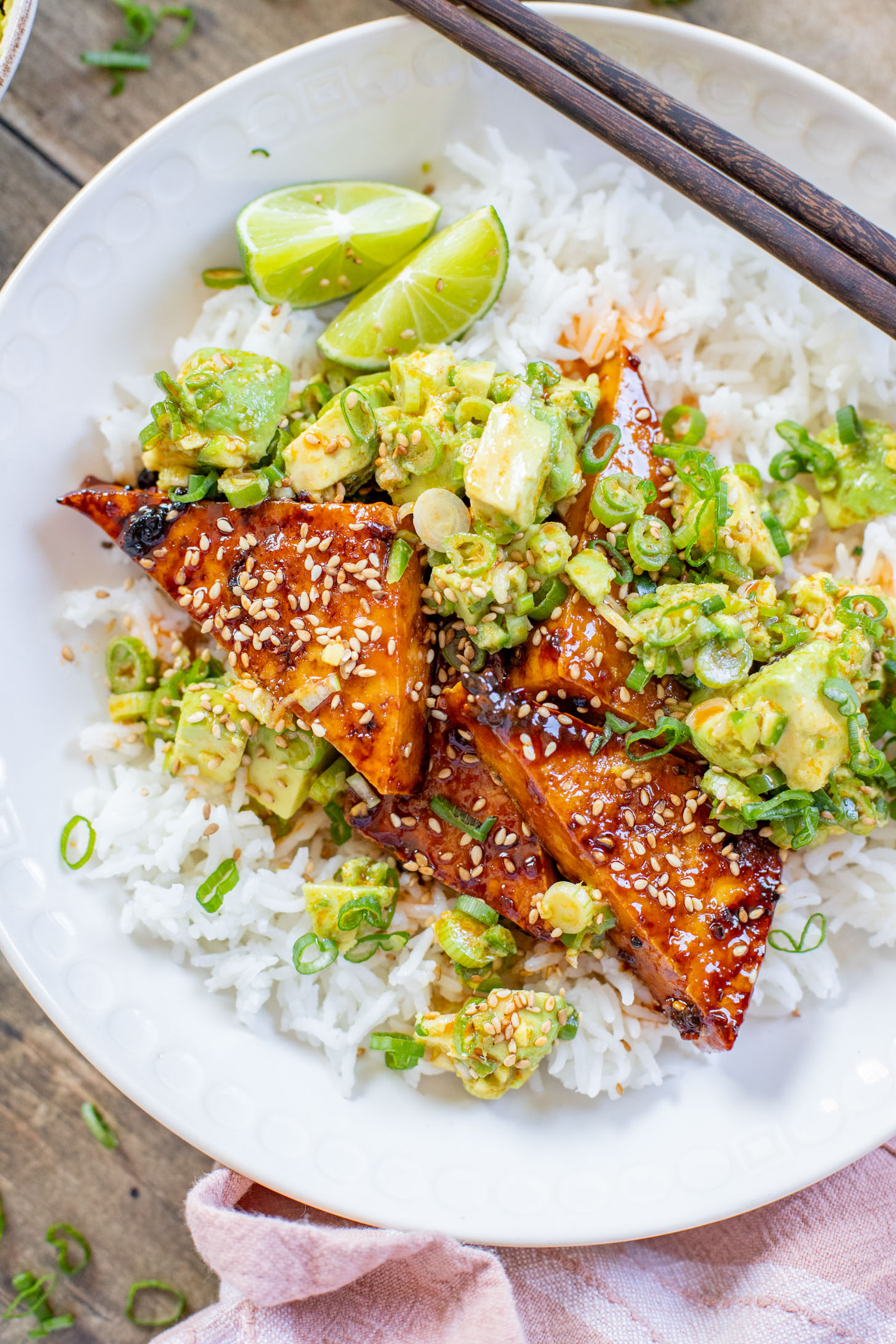 These Teriyaki Tofu Rice Bowls are a quick weeknight dinner. The tofu is sticky & crispy and is topped off with a ginger avocado salsa | ThisSavoryVegan.com