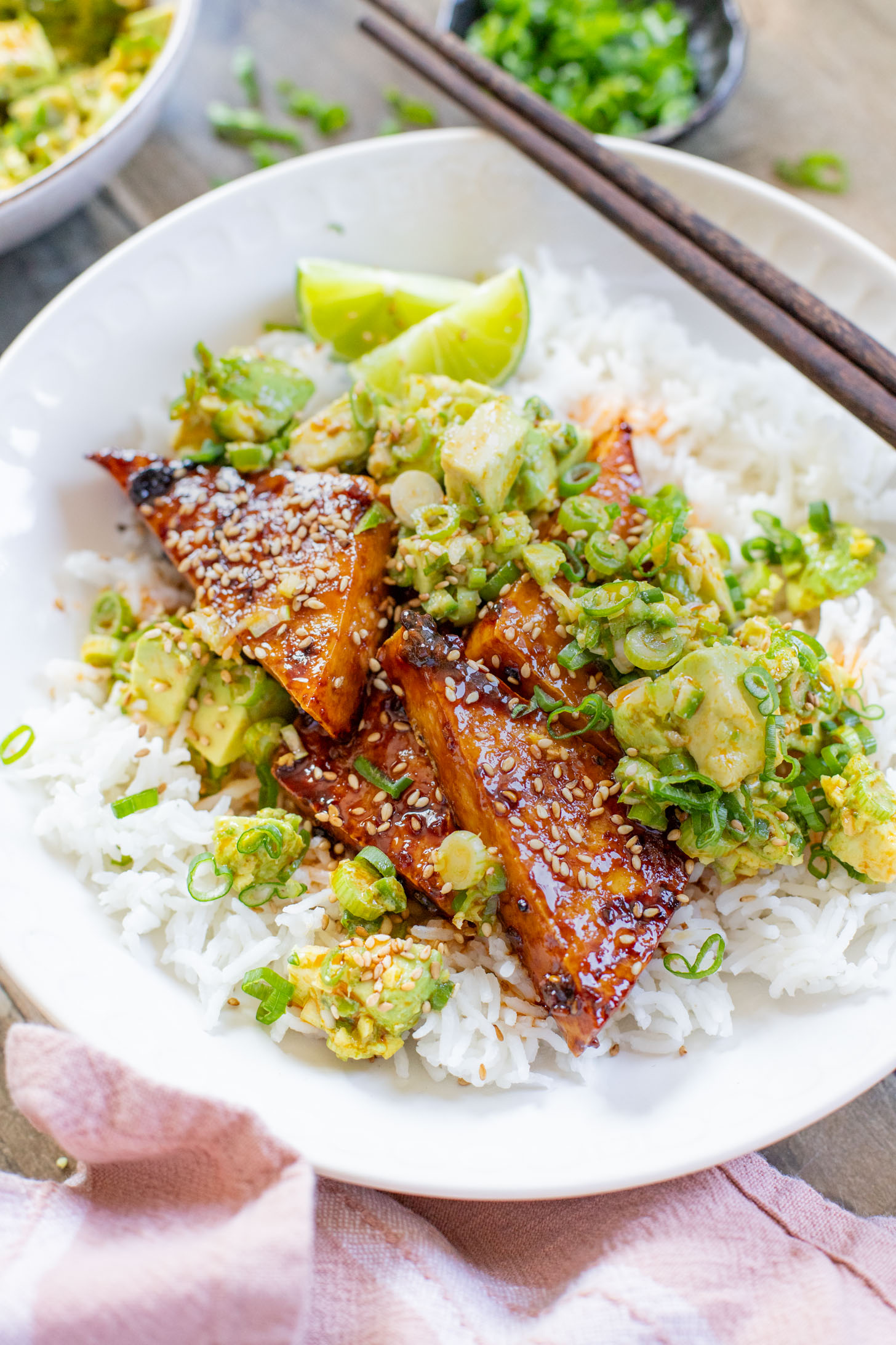 These Teriyaki Tofu Rice Bowls are a quick weeknight dinner. The tofu is sticky & crispy and is topped off with a ginger avocado salsa | ThisSavoryVegan.com