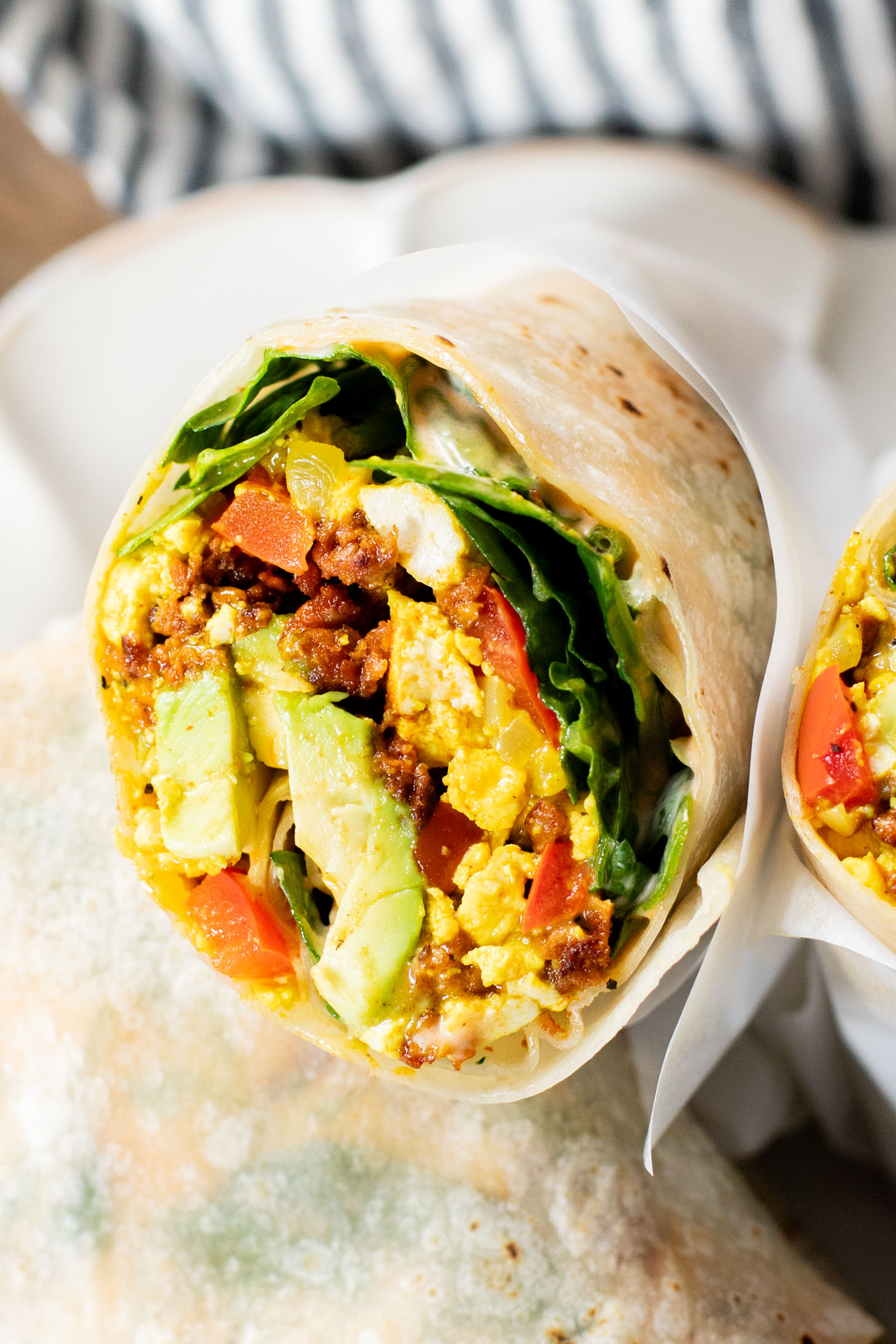 These Tofu Scramble Breakfast Burritos are the perfect vegan brunch idea! Filled with a tasty tofu scramble, soyrizo & avocado | ThisSavoryVegan.com